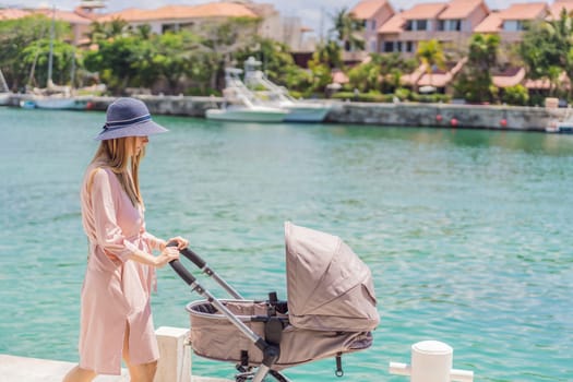 A young mother walks along the scenic waterfront, pushing a baby stroller with her child inside. A peaceful and heartwarming moment of motherhood, relaxation, and outdoor bonding by the sea.
