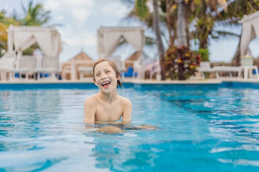 A young boy joyfully swims in a tropical pool surrounded by lush greenery. The vibrant scene captures the essence of summer fun, adventure, and carefree childhood moments in a refreshing outdoor setting.