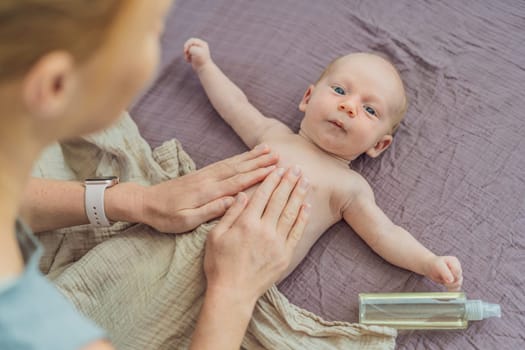 A mother gently massages her 1-month-old baby with baby oil after a bath. This tender moment highlights the bond between parent and child, promoting relaxation, baby care, and the importance of skin-to-skin contact.