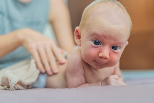 A mother gently massages her 1-month-old baby with baby oil after a bath. This tender moment highlights the bond between parent and child, promoting relaxation, baby care, and the importance of skin-to-skin contact.