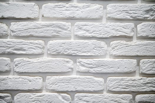 close-up of a white brick wall. large white brick, with an uneven surface.