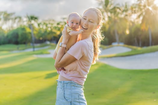 Young mother enjoying a peaceful walk in the park with her one-month-old baby. Motherhood, bonding, and outdoor family time concept.