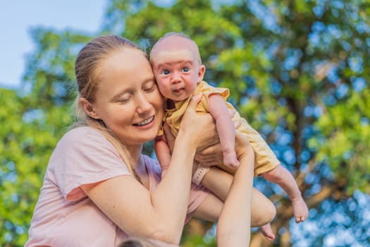 Young mother, teenage son, and one-month-old baby enjoying quality family time in the park. Multigenerational bonding and outdoor family love concept.