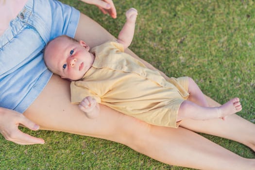 Young mother enjoying a peaceful walk in the park with her one-month-old baby. Motherhood, bonding, and outdoor family time concept.