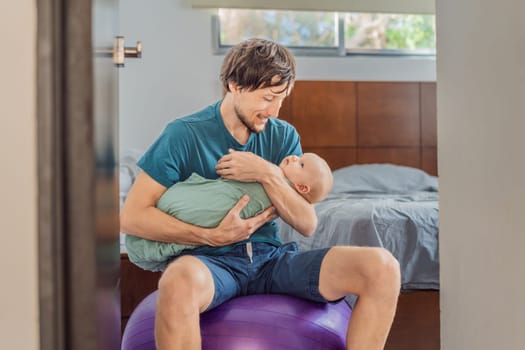 A father sits on a fitness ball in a cozy bedroom, gently rocking his baby wrapped in a soft muslin swaddle. A nurturing and soothing moment of fatherhood and care. Parenting, bonding, and comfort concept.