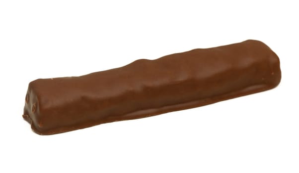 A rich chocolate bar lies on a clean white surface, showcasing its smooth, glossy coating in natural light.