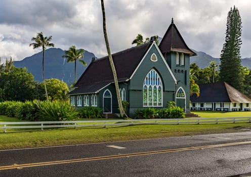 The Waioli Huiia Church stands in Hanalei, Kauai, with the majestic mountains in the background, after a heavy storm over the hills