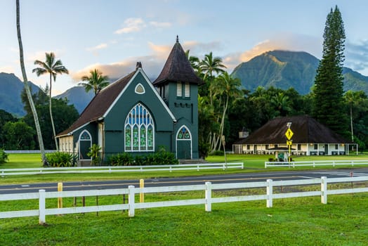 The Waioli Huiia Church stands in Hanalei, Kauai, with the majestic mountains in the background at sunrise