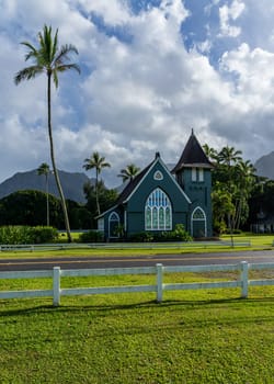 The Waioli Huiia Church stands in Hanalei, Kauai, with the majestic mountains in the background, after a heavy storm over the hills