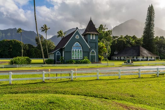 The Waioli Huiia Church stands in Hanalei, Kauai, with the majestic mountains in the background, after a heavy storm over the hills