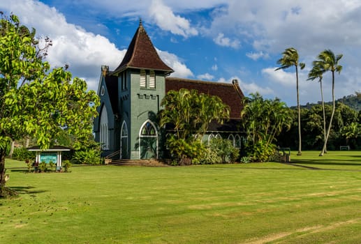 Hanalei, Kauai - 30 January 2025: Waioli Huiia Church stands in Hanalei, Kauai, with the majestic mountains in the background