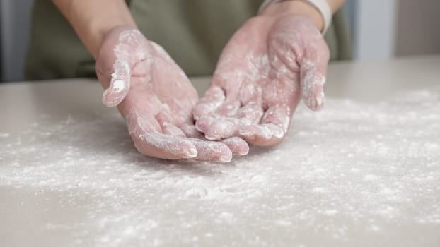 Hands, flour and baking by woman in a kitchen for bread, pizza or handmade food at home. Wheat, palm and female chef with messy fingers from cooking, fun and preparing diy, pasta or cake in her house
