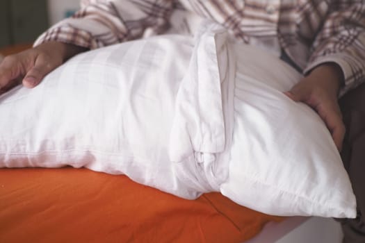Woman Puts Pillow Into Pillowcase