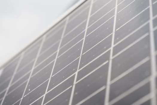 Close-up view of solar panels reflecting sunlight, promoting sustainability.