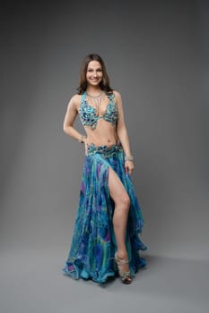 A skilled dancer showcases her talent in a colorful costume, featuring intricate details and a flowing skirt, captivating the audience.