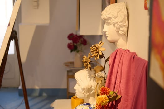 Side view of Apollo plaster head on the desk, displayed for learning drawing in a creative art class or painter workshop. Education. Learning. Fine and visual art. Copy advertising space