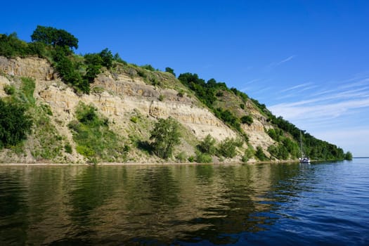 Beautiful landscape from the river to the sandy rocky shore. High quality photo