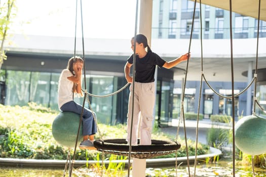 A schoolgirl plays on the playground in the city's backyard. High quality photo