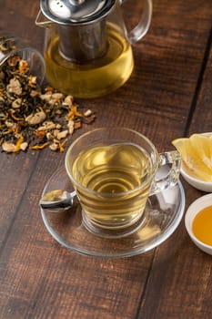 Freshly brewed hot winter tea on a wooden table