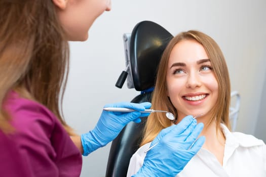 Beautiful woman patient visiting dentist for teeth check up. Teeth treatment
