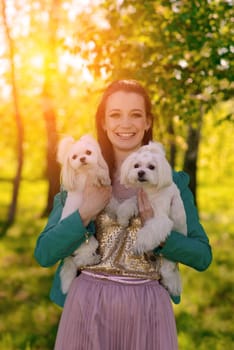 Puppy white dog is running with it's owner. Concept about friendship, animal and freedom.