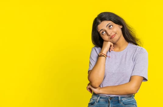 Indian young woman tired bored indifferent expression, exhausted of tedious story, not interested in communication talk, displeasure, uninteresting. Arabian girl isolated on yellow background indoors