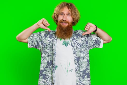 I am the best, choose me. Young happy man feeling very proud pointing herself, looking self-confident, overjoyed by success, making choice. Redhead adult guy isolated on green chroma key background