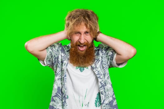 Dont want to hear, listen, quiet. Frustrated annoyed irritated man covering ears gesturing no, avoiding advice ignoring unpleasant noise loud voices. Redhead guy isolated on chroma key background