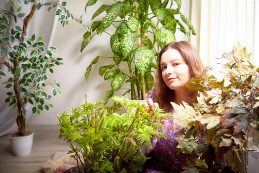 A woman engages with various plants in a bright, well-lit room, creating a calming atmosphere filled with greenery and nature.