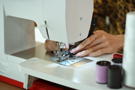 Close up of designer or tailor working on a sewing machine.
