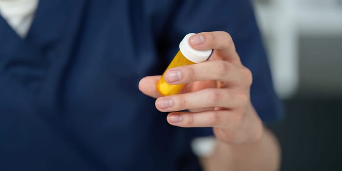 A medical student carefully analyzes a prescription bottle, underscoring the significance of pharmaceutical knowledge in healthcare.