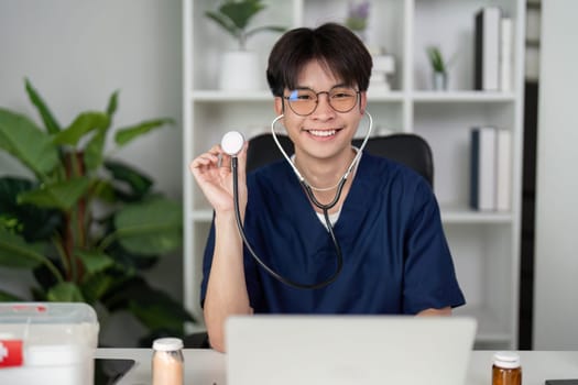 A joyful medical student in scrubs smiles while holding a stethoscope, embodying enthusiasm for healthcare and patient care.