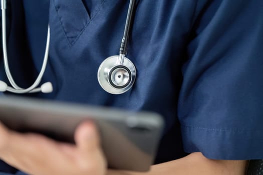 A healthcare professional interacts with a tablet, highlighting the integration of technology in modern medical practices.