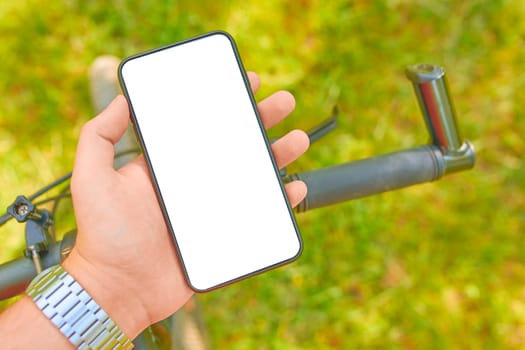 Man with a smartphone on a Bicycle trains on offroad. mockup.