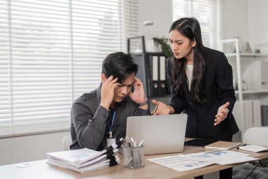 Two professional colleagues discuss challenges in a modern office, emphasizing the importance of teamwork and effective communication.