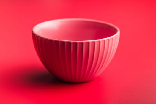 Empty red bowl on a red background.