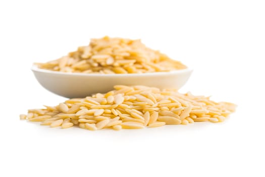 Orzo, kritharaki, risoni pasta. Uncooked dry pasta in bowl isolated on a white background.