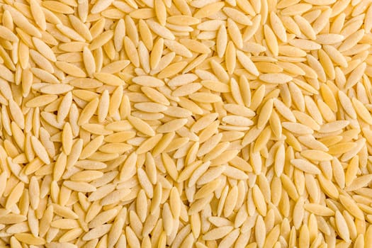 Orzo, kritharaki, risoni pasta. Uncooked dry pasta. Top view.