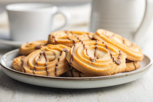 Sweet chocolate cookies on plate on a kitchen table.