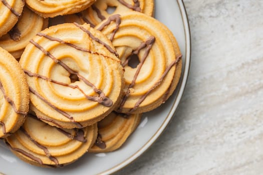 Sweet chocolate cookies on plate on a kitchen table. Top view.