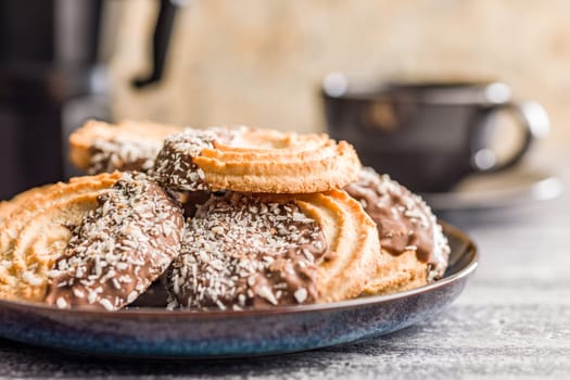 Sweet chocolate cookies on plate on a kitchen table.