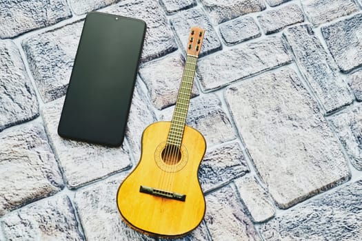a brief record of facts, topics, or thoughts, written down as an aid to memory. a stringed musical instrument
