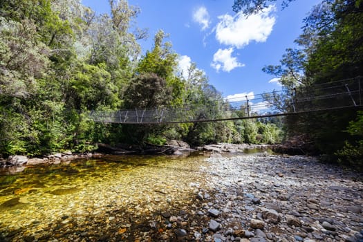 Frenchmans Cap Suspended Bridge in Franklin-Gordon Wild Rivers National Park on a hot summer's day in Tasmania, Australia