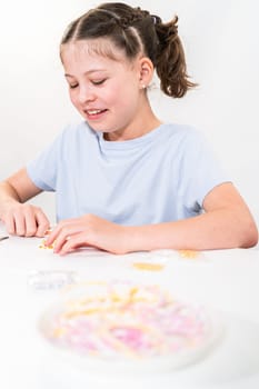 Little girl enjoys crafting colorful bracelets with vibrant clay beads set.