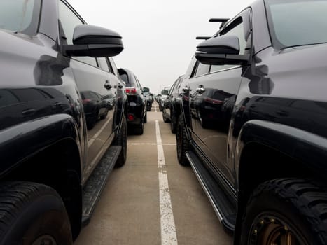 Endless row of cars for sale in street parking lot. Auto shop on street for convenient selection of cars in large parking lot. Selecting and purchasing new car from large assortment