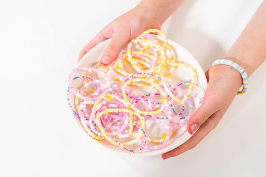 Little girl's charming bracelets adorned with clay and sea beads.