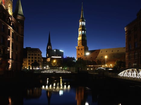 Hamburg at night. View from the Speicherstadt to the St. Katharinen Church