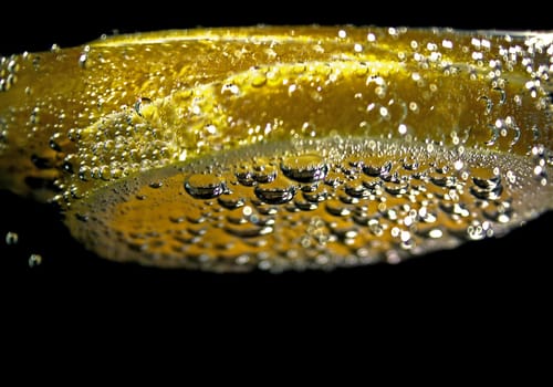 Lemon placed in a glass of mineral water and illuminated.