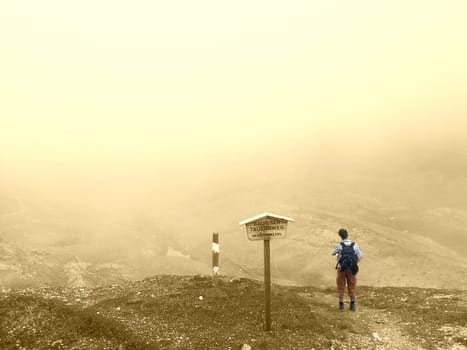 Lonely hiker in the clouds on the Grossglockner High Alpine Road,Carinthia,Austria.