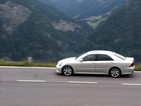 Toyota Crown - all-Japanese model - driving past on high alpine road